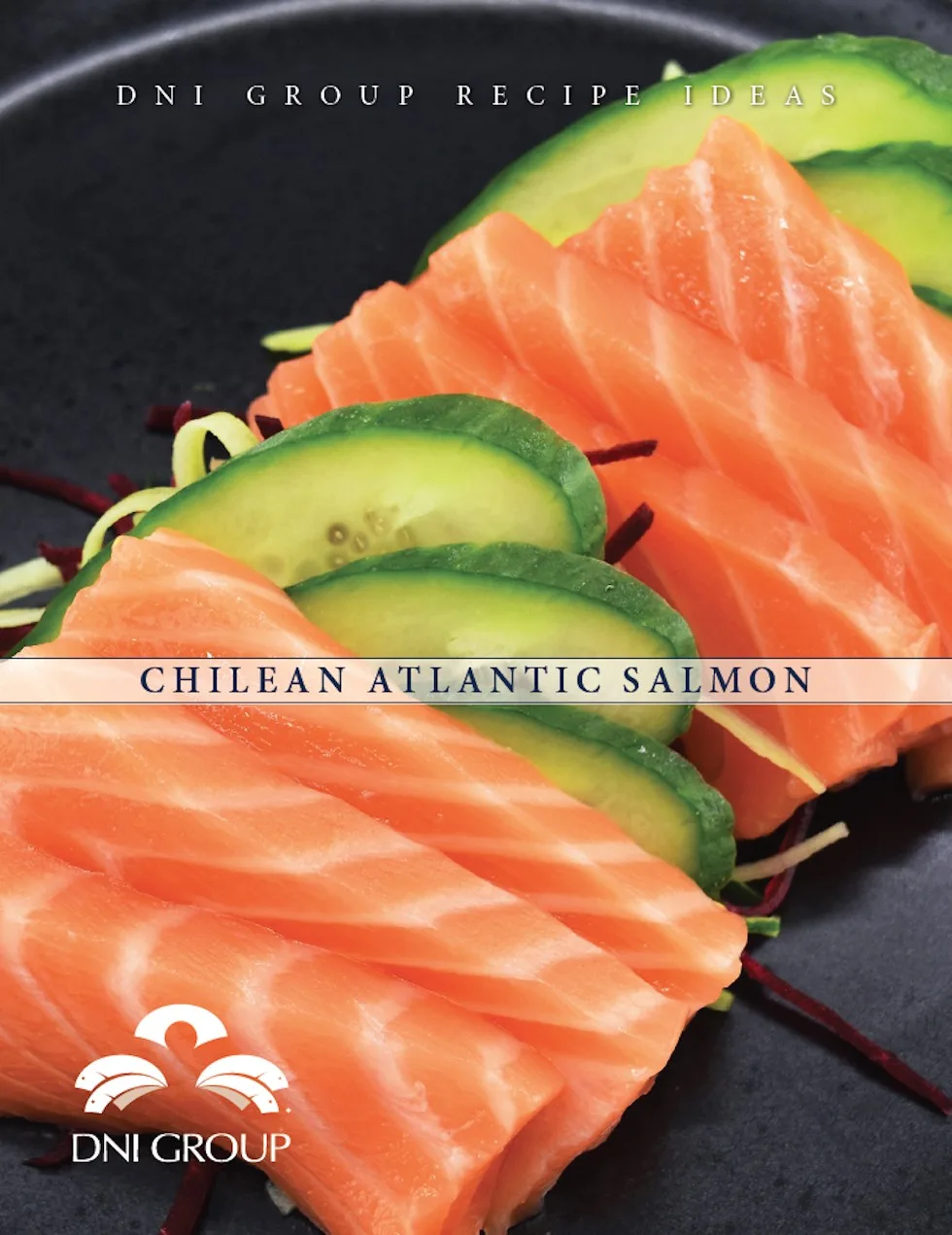 Premium Chilean Atlantic salmon slices with fresh avocado and microgreens on dark plate for fine dining wholesale distribution.
